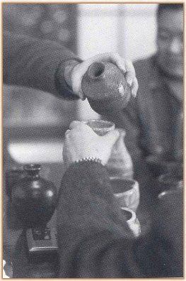 Pouring from a Tokkuri (flask) into a Guinomi (cup)